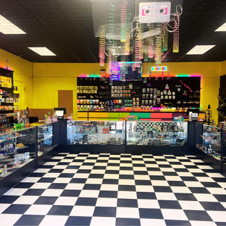 Interior of a store with checkered floor, colorful decor, and product displays.